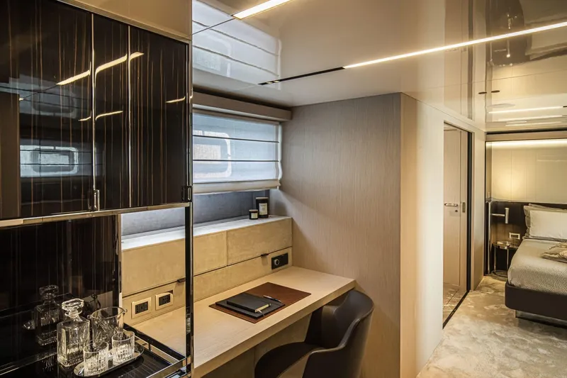  Yacht Photos Pics Luxurious interior of 2024 Cranchi Sessantasette 67 yacht with modern desk and bedroom.