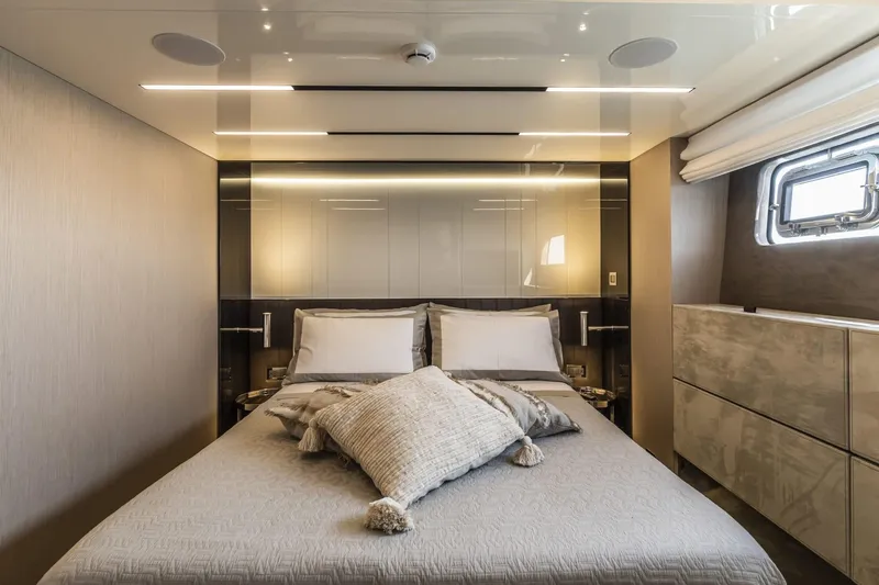  Yacht Photos Pics Luxurious bedroom interior of 2024 Cranchi Sessantasette 67 yacht, featuring modern design and elegant decor.