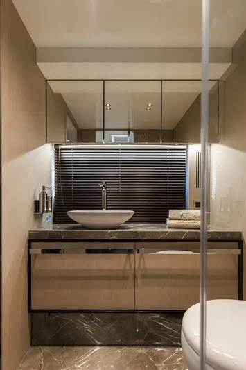  Yacht Photos Pics Luxurious bathroom interior on 2024 Cranchi Sessantasette 67 yacht, featuring modern sink and elegant finishes.