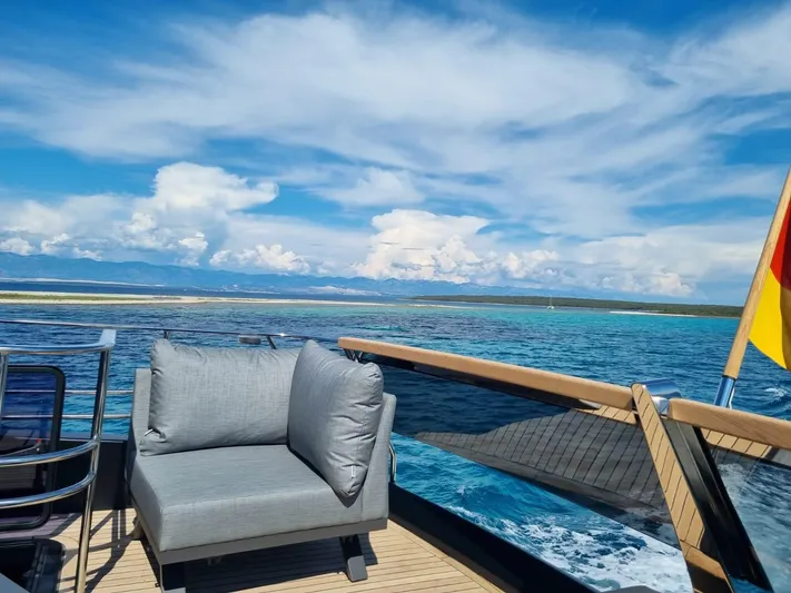  Yacht Photos Pics Luxurious 2024 Cranchi Sessantasette 67 yacht deck with ocean view and comfortable seating.