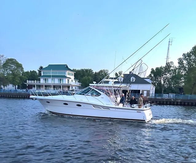  Yacht Photos Pics 2006 Tiara Yachts 3600 Open cruising on a scenic waterway near waterfront homes.
