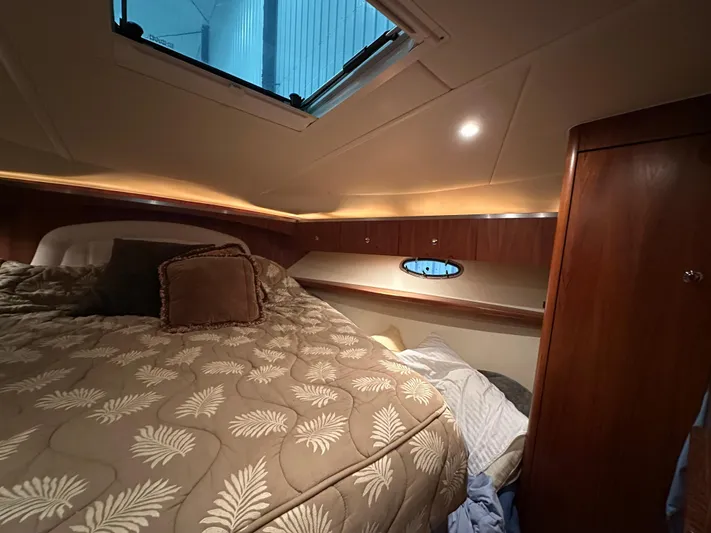  Yacht Photos Pics Cozy cabin interior of 2006 Tiara Yachts 3600 Open with elegant bedding and wood accents.