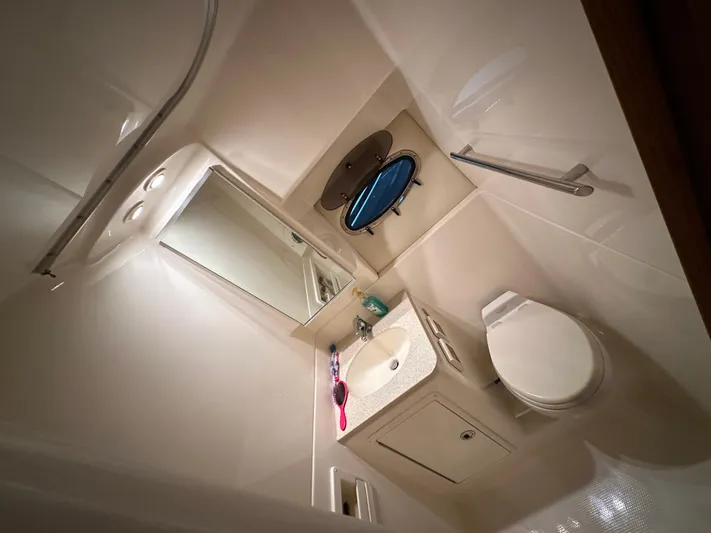  Yacht Photos Pics Compact bathroom in 2006 Tiara Yachts 3600 Open, featuring sink, mirror, and toilet.