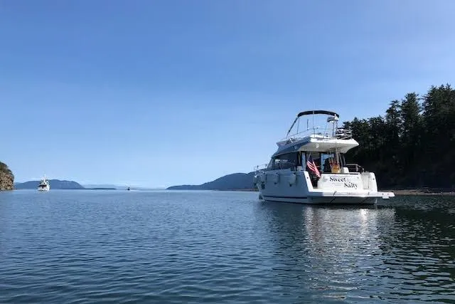 Sweet & Salty Yacht Photos Pics 2019 Jeanneau Velasco 37F yacht anchored in serene coastal waters.