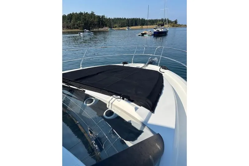 Sweet & Salty Yacht Photos Pics 2019 Jeanneau Velasco 37F yacht anchored in a serene bay with other boats.