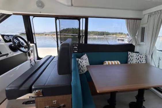 Sweet & Salty Yacht Photos Pics Interior of 2019 Jeanneau Velasco 37F yacht with dining area and scenic window view.