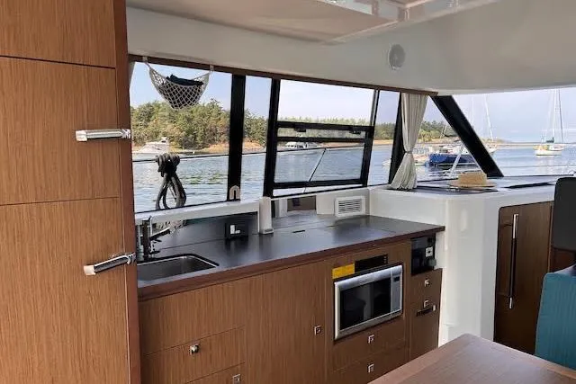 Sweet & Salty Yacht Photos Pics Interior of 2019 Jeanneau Velasco 37F yacht with modern kitchen and scenic window view.