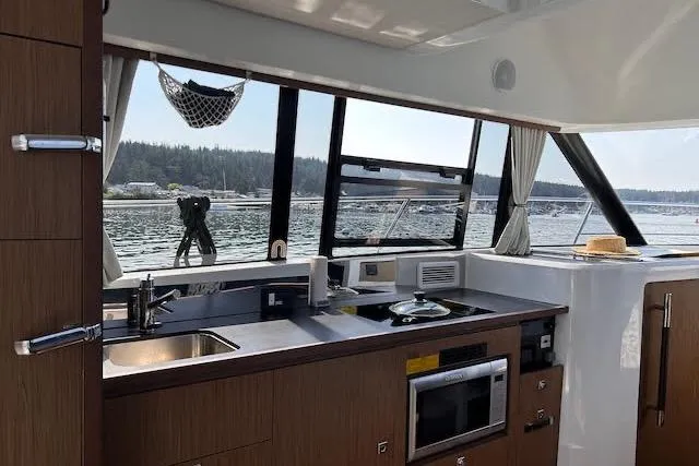 Sweet & Salty Yacht Photos Pics Interior of 2019 Jeanneau Velasco 37F yacht with modern kitchen and scenic window view.