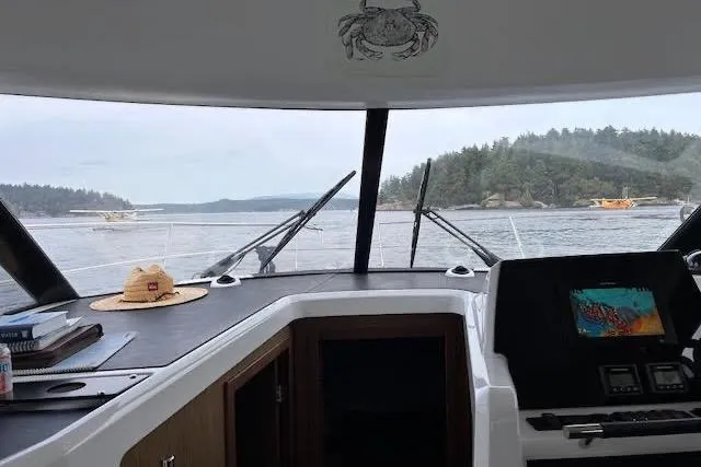Sweet & Salty Yacht Photos Pics Interior view from a 2019 Jeanneau Velasco 37F boat, overlooking a scenic waterway.