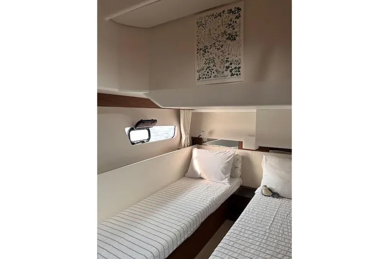 Sweet & Salty Yacht Photos Pics Interior cabin of 2019 Jeanneau Velasco 37F with twin beds and nautical decor.