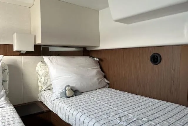 Sweet & Salty Yacht Photos Pics Cozy cabin interior of 2019 Jeanneau Velasco 37F with twin beds and plush bedding.