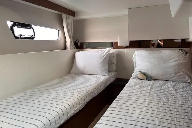 Sweet & Salty Yacht Photos Pics Interior cabin of 2019 Jeanneau Velasco 37F with twin beds and striped bedding.