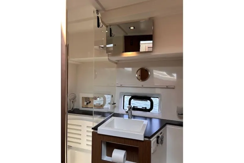 Sweet & Salty Yacht Photos Pics 2019 Jeanneau Velasco 37F yacht bathroom with modern sink and mirror.