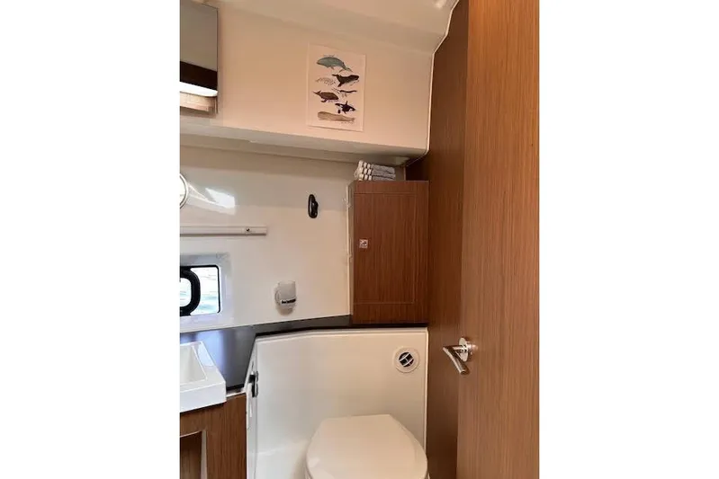 Sweet & Salty Yacht Photos Pics Bathroom interior of 2019 Jeanneau Velasco 37F yacht, featuring modern fixtures and wood accents.
