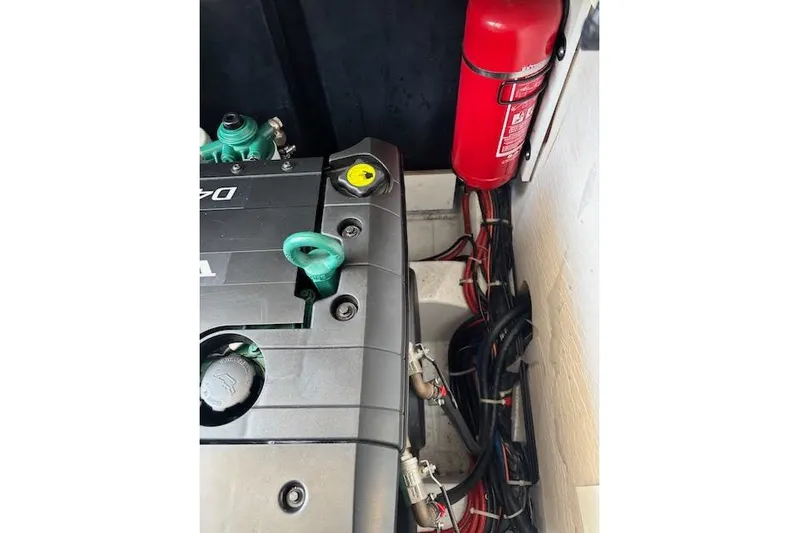 Sweet & Salty Yacht Photos Pics Engine compartment of 2019 Jeanneau Velasco 37F with fire extinguisher and wiring.