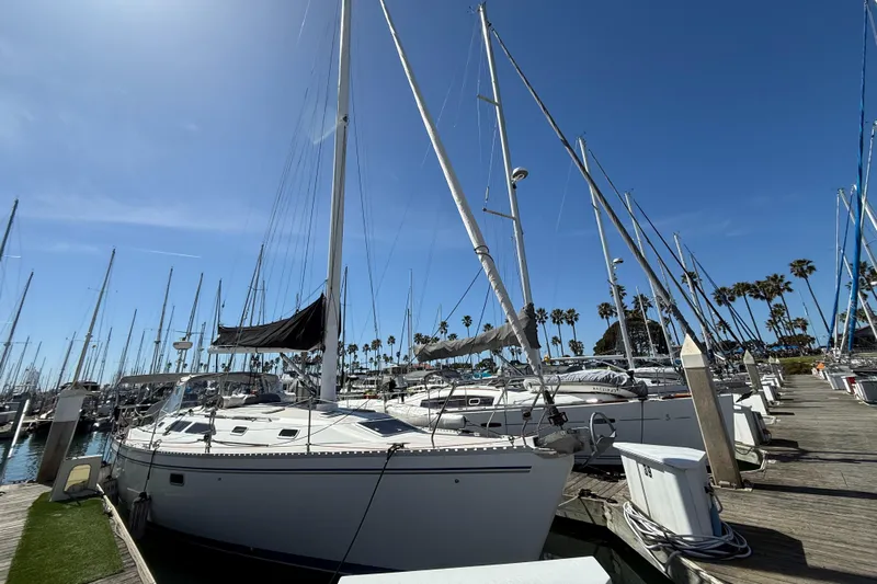  Yacht Photos Pics Sailboats docked at a marina under clear blue skies, featuring a 1996 Catalina 400.