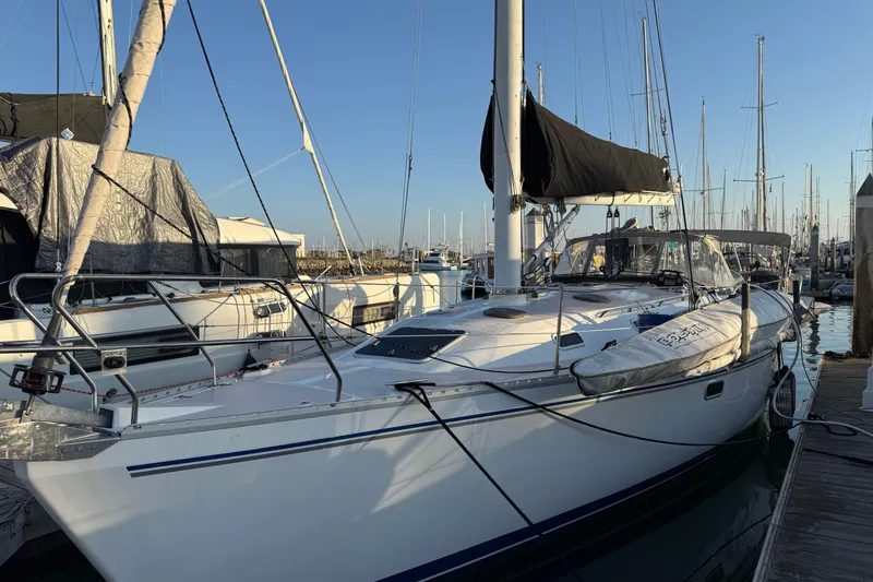  Yacht Photos Pics 1996 Catalina 400 sailboat docked at marina, featuring sleek design and black sail cover.
