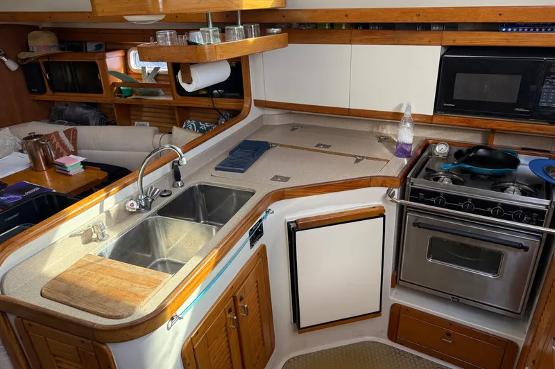  Yacht Photos Pics Cozy kitchen in a 1996 Catalina 400 sailboat with stove, sink, and microwave.