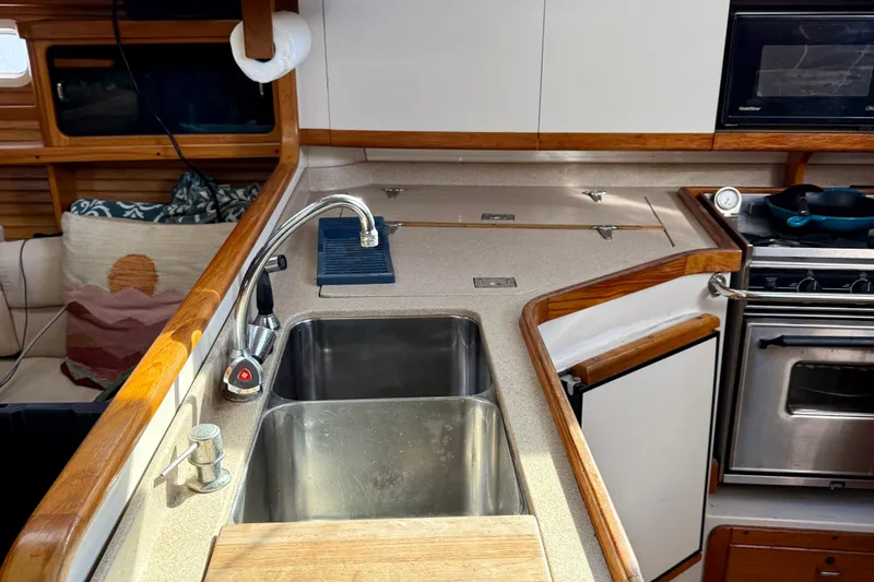  Yacht Photos Pics Catalina 400 yacht kitchen with sink, stove, and wooden accents, 1996 model.