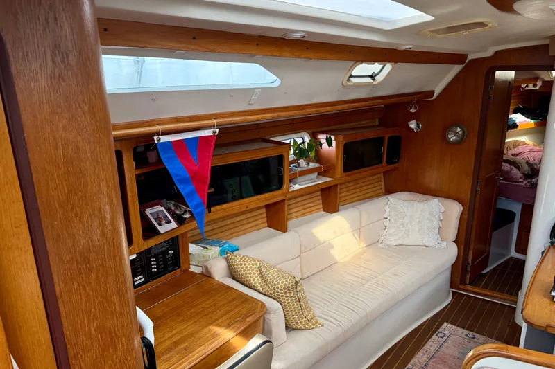  Yacht Photos Pics Interior of a 1996 Catalina 400 sailboat with cozy seating and wooden accents.