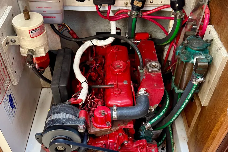  Yacht Photos Pics Engine compartment of a 1996 Catalina 400 sailboat, featuring a red engine and various components.