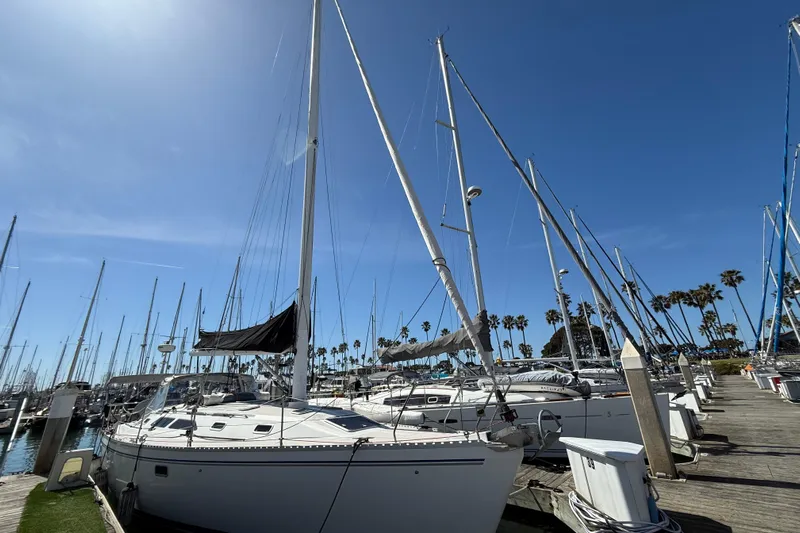  Yacht Photos Pics Catalina 400 sailboat docked at marina, clear blue sky, palm trees in background.