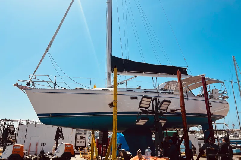  Yacht Photos Pics 1996 Catalina 400 sailboat in dry dock, undergoing maintenance under clear blue sky.