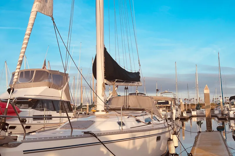 Yacht Photos Pics 1996 Catalina 400 sailboat docked in a marina under a clear blue sky.