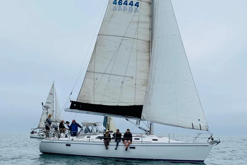  Yacht Photos Pics Sailboat Catalina 400, 1996 model, with crew sailing on open water.