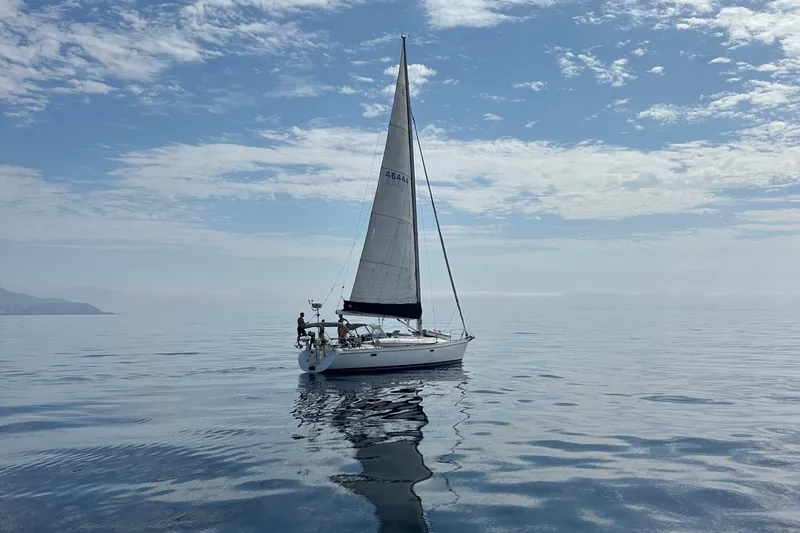  Yacht Photos Pics Sailboat Catalina 400 (1996) on calm sea under a partly cloudy sky.