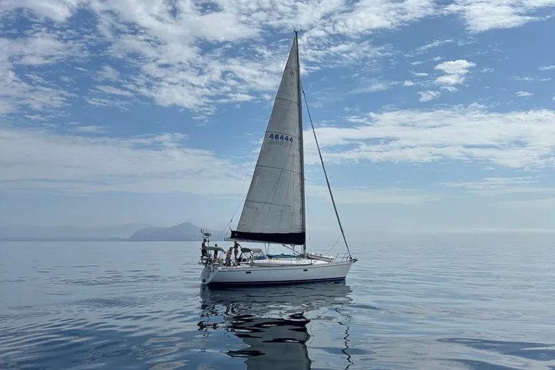  Yacht Photos Pics Sailboat Catalina 400 (1996) gliding on calm waters under a partly cloudy sky.