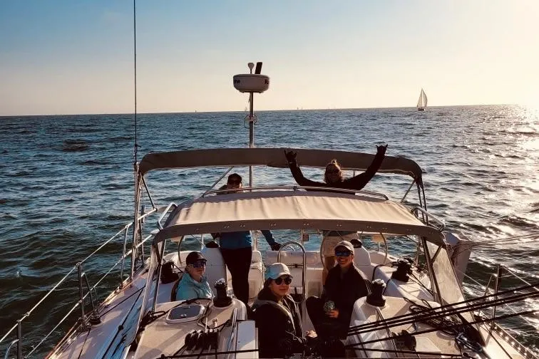  Yacht Photos Pics People enjoying a sunny day on a 1996 Catalina 400 sailboat at sea.