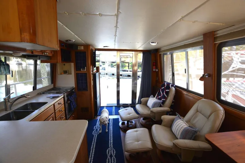 Standing By Yacht Photos Pics Interior of 2004 Mainship 400 Trawler with cozy seating and kitchen area.