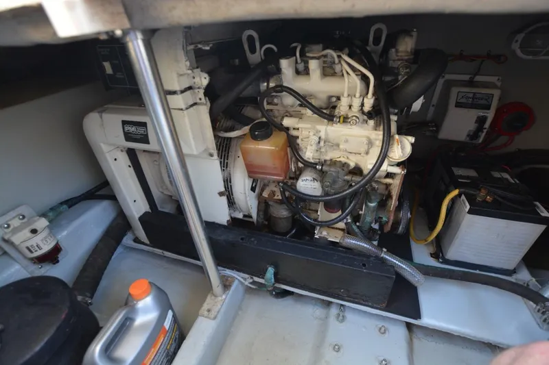Standing By Yacht Photos Pics Engine room of a 2004 Mainship 400 Trawler with visible components and battery.