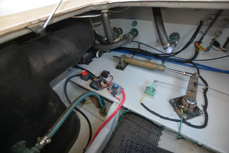 Standing By Yacht Photos Pics Engine compartment of a 2004 Mainship 400 Trawler, showcasing wiring and mechanical components.