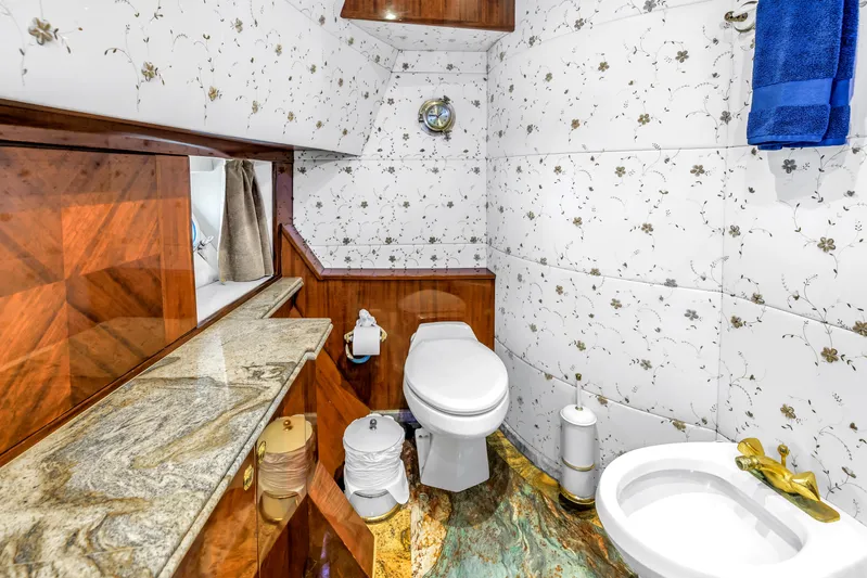 Star Saphire Yacht Photos Pics Luxurious bathroom on Bilgin 117 yacht, 2007 model, featuring elegant floral tiles and marble accents.