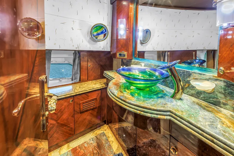 Star Saphire Yacht Photos Pics Luxurious yacht bathroom with green glass sink, marble countertop, and wooden cabinetry, Bilgin 117, 2007.