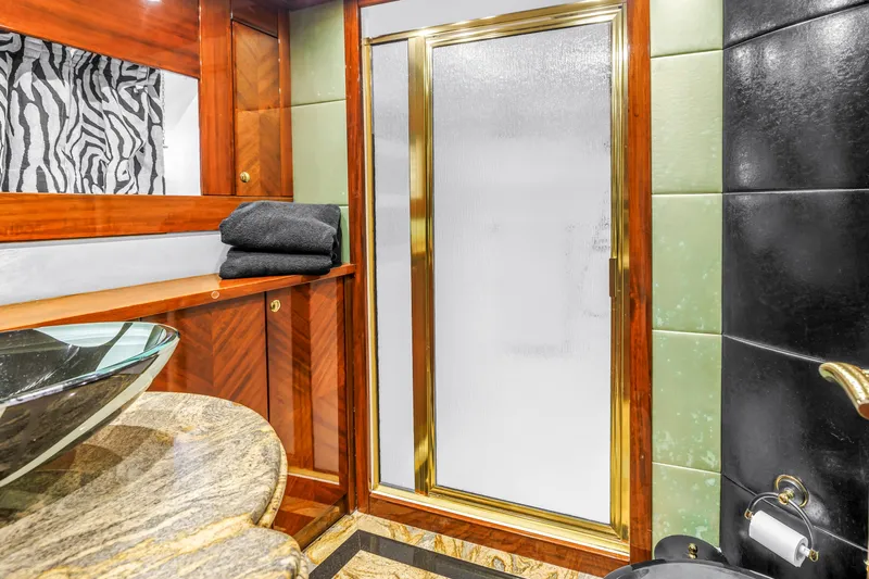 Star Saphire Yacht Photos Pics Luxurious bathroom in 2007 Bilgin 117 yacht with elegant wood and marble finishes.