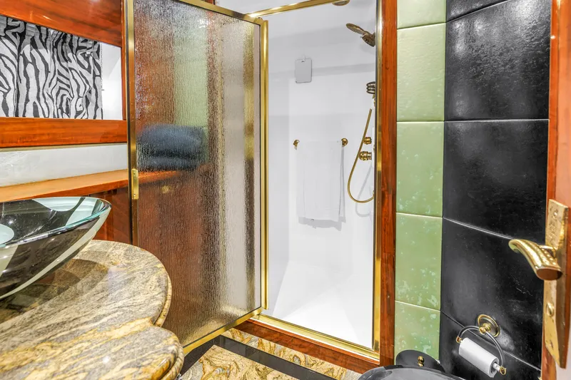 Star Saphire Yacht Photos Pics Luxurious bathroom in 2007 Bilgin 117 yacht with glass shower and elegant fixtures.