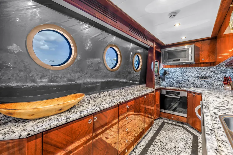 Star Saphire Yacht Photos Pics Luxurious Bilgin 117 yacht kitchen, 2007 model, featuring granite countertops and wooden cabinetry.