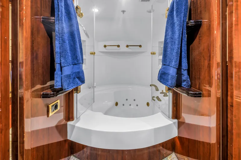 Star Saphire Yacht Photos Pics Luxurious Bilgin 117 yacht bathroom with jacuzzi, blue towels, and elegant wood paneling, 2007 model.