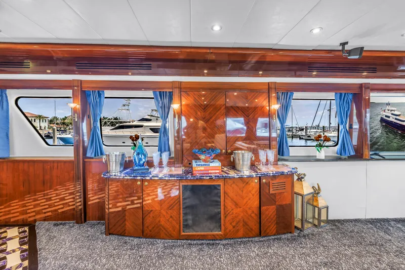 Star Saphire Yacht Photos Pics Luxurious interior of 2007 Bilgin 117 yacht with elegant wood paneling and blue curtains.