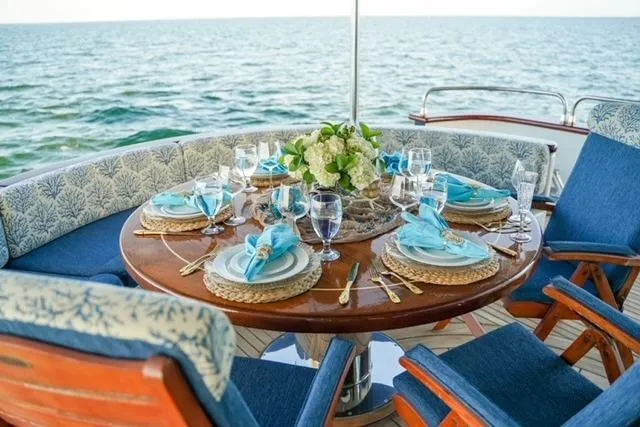 Star Saphire Yacht Photos Pics Luxurious dining setup on Bilgin 117 yacht, 2007, with ocean view and elegant tableware.