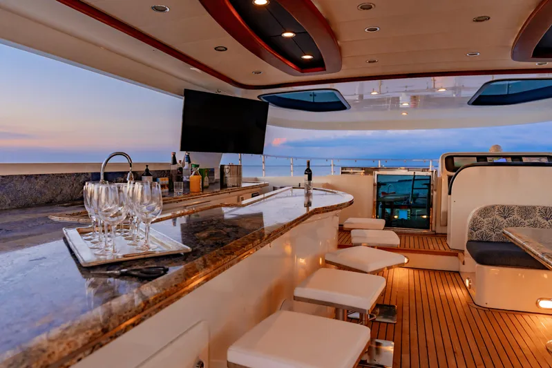 Star Saphire Yacht Photos Pics Luxurious Bilgin 117 yacht interior with bar, seating, and ocean view at sunset, 2007 model.