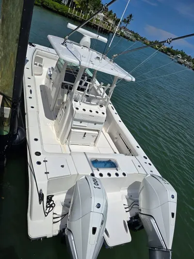  Yacht Photos Pics 2023 Caymas 30 CT boat docked on calm water, featuring dual engines and spacious deck.