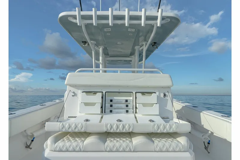  Yacht Photos Pics Manufacturer Provided Image: Invincible 33 Catamaran 2023, luxury seating and storage, ocean backdrop.