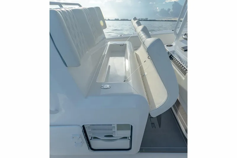  Yacht Photos Pics Manufacturer Provided Image: 2023 Invincible 33 Catamaran interior seating with storage, ocean view.