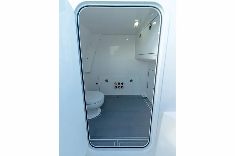  Yacht Photos Pics Manufacturer Provided Image: Interior of 2023 Invincible 33 Catamaran, featuring a compact, modern bathroom space.