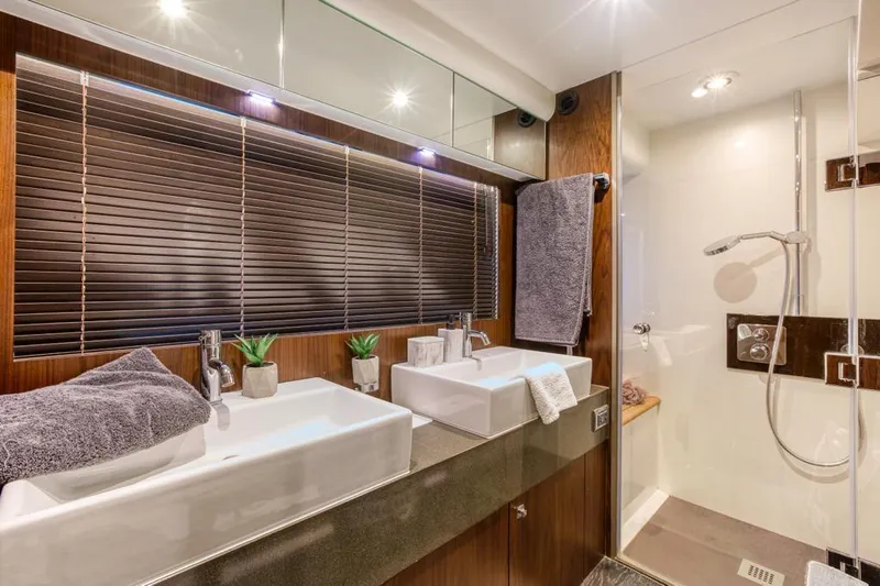  Yacht Photos Pics Luxurious bathroom in 2016 Fairline Squadron 65 yacht with dual sinks and modern shower.