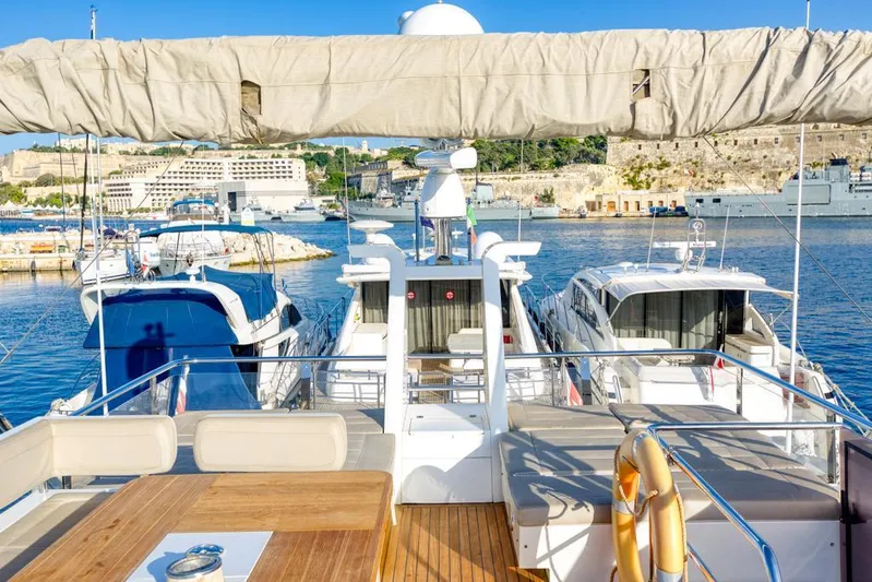  Yacht Photos Pics 2016 Fairline Squadron 65 yacht docked in a sunny marina with scenic background.